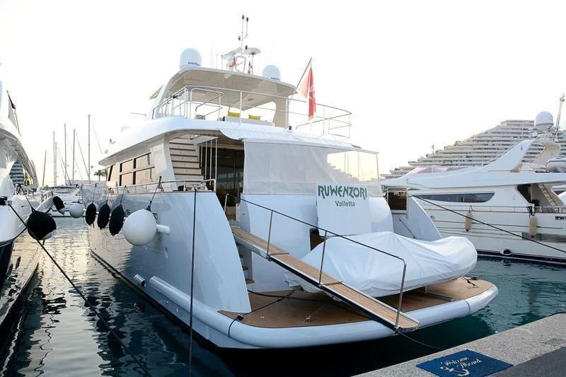 a boat docked at a pier aboard MR GU Yacht for Sale