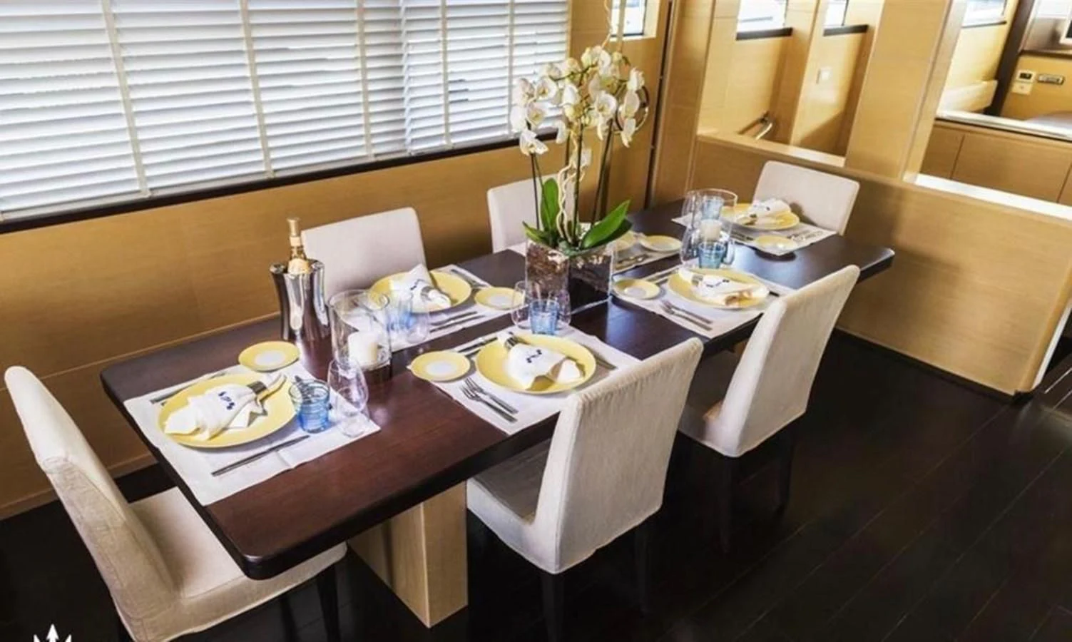 a table set with plates and cups aboard MR GU Yacht for Sale