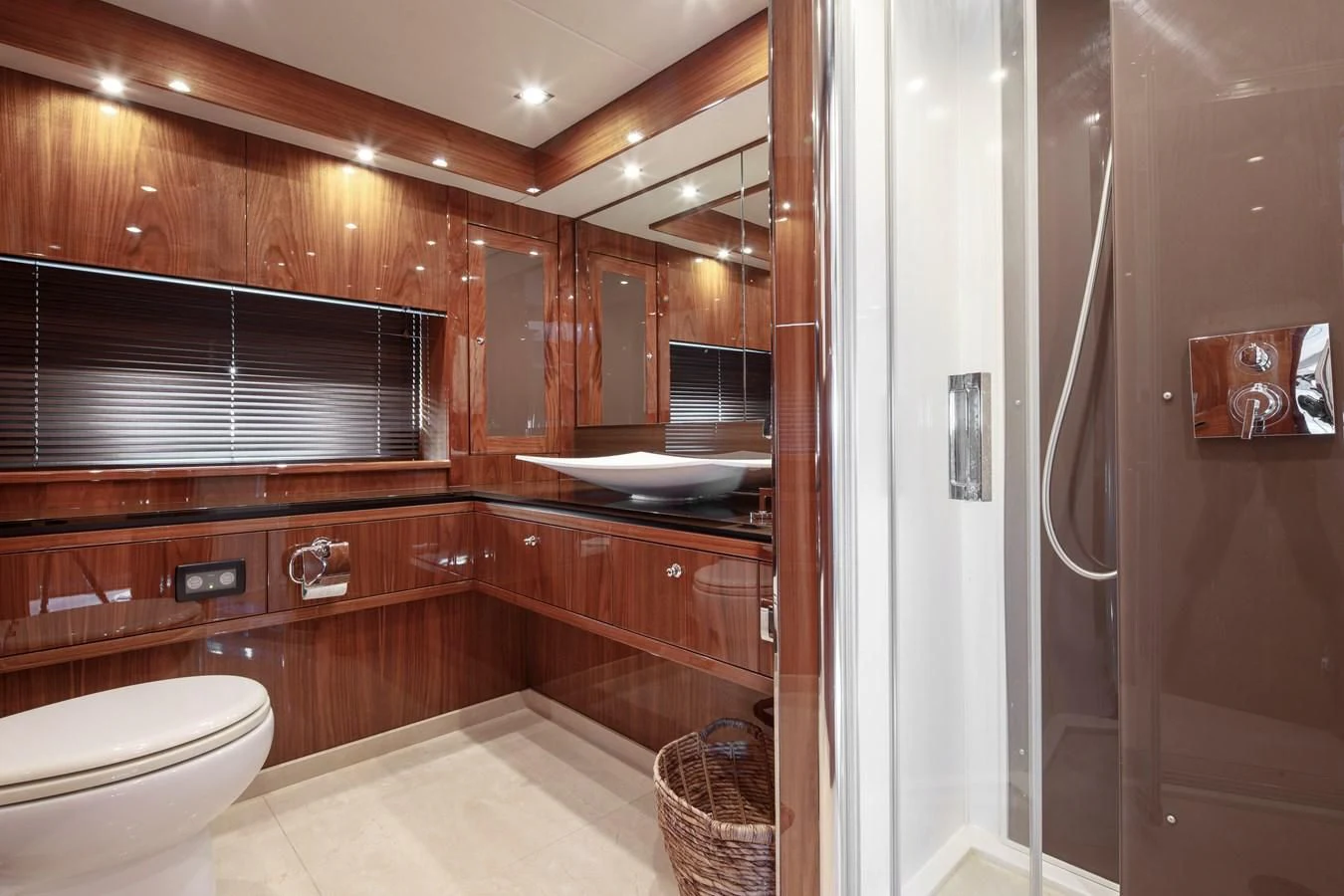 a bathroom with wooden cabinets aboard SSM Yacht for Sale