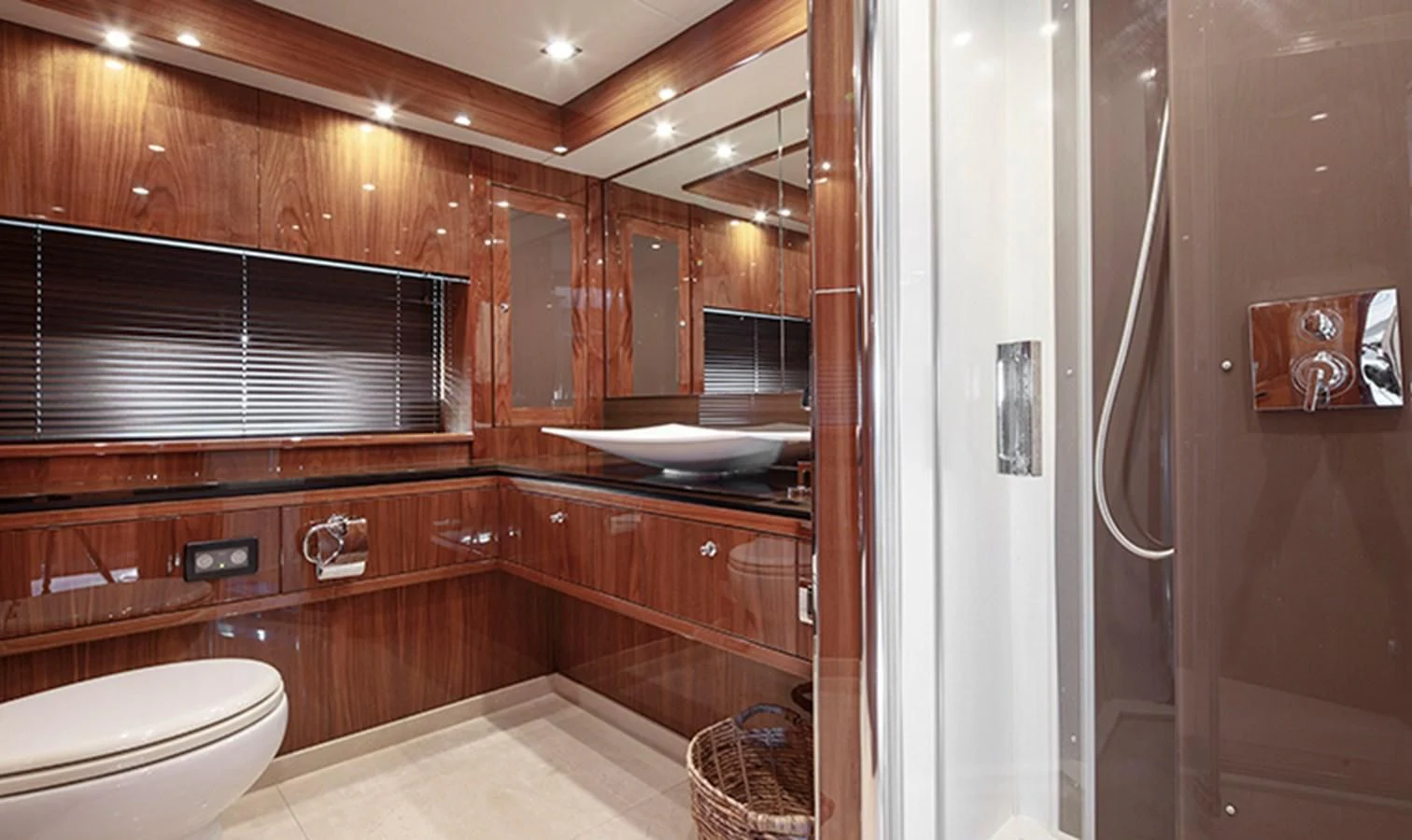 a bathroom with wooden cabinets aboard SSM Yacht for Sale