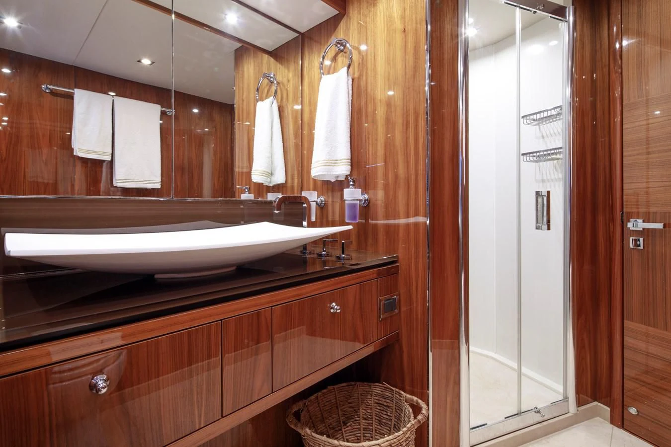 a bathroom with a large mirror aboard SSM Yacht for Sale