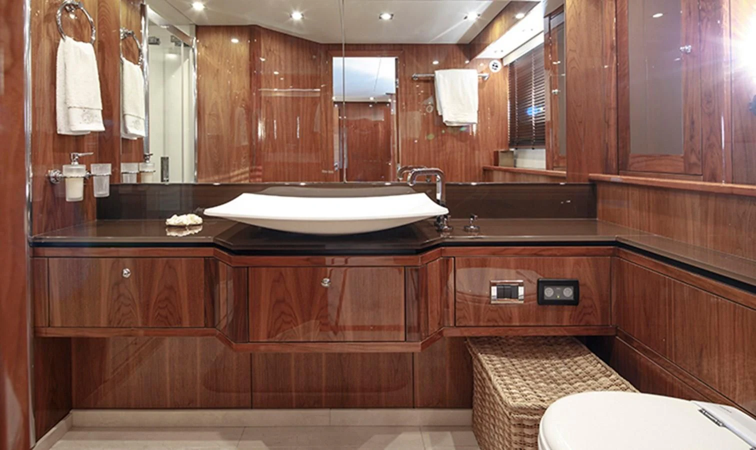 a bathroom with a large mirror aboard SSM Yacht for Sale