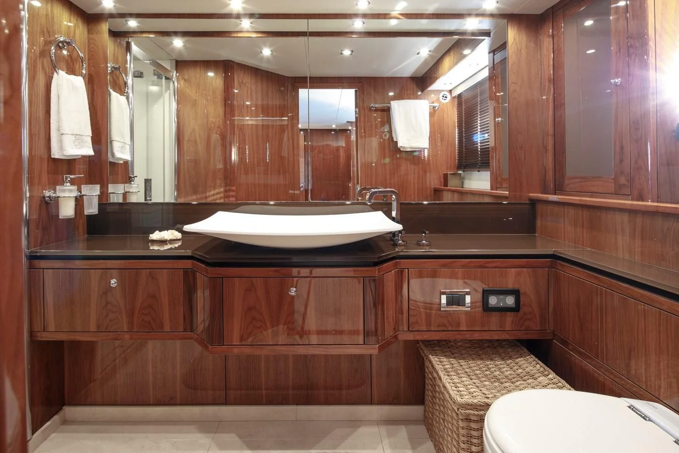 a bathroom with a large mirror aboard SSM Yacht for Sale