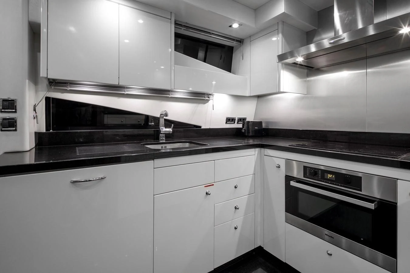a kitchen with white cabinets aboard SSM Yacht for Sale
