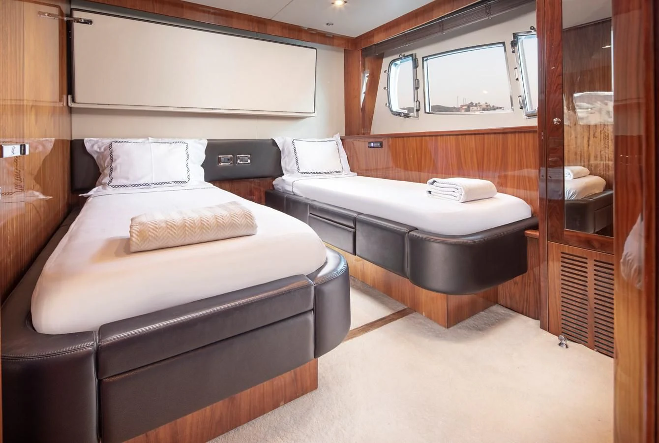 a room with a bed and a mirror aboard SSM Yacht for Sale