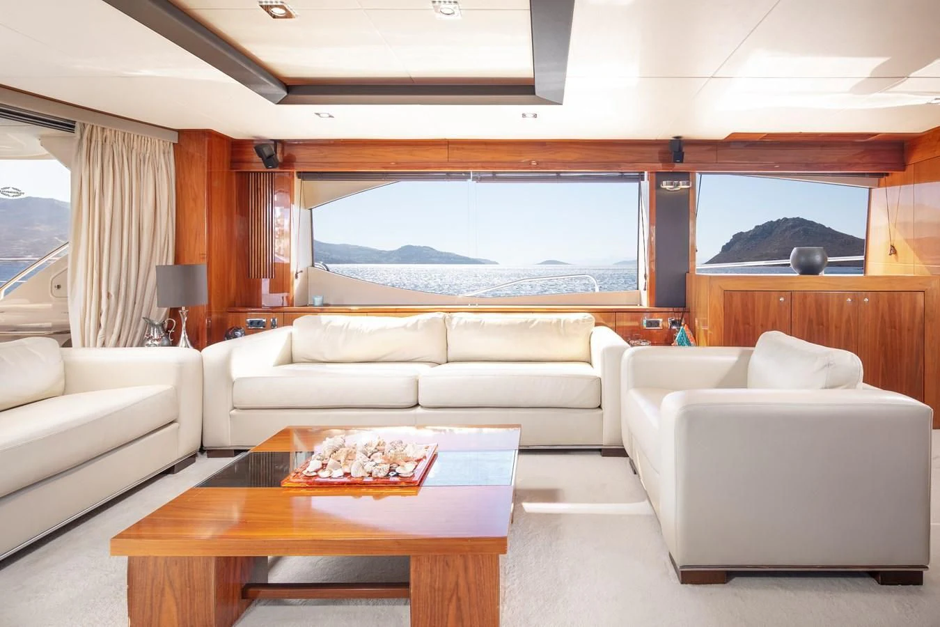 a living room with a large window aboard SSM Yacht for Sale