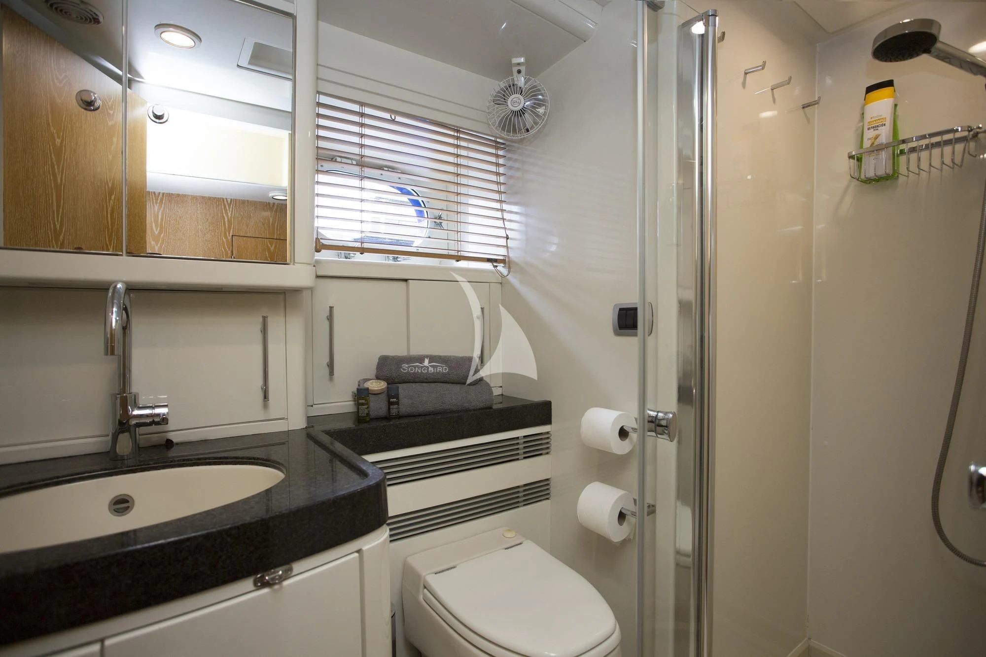 a bathroom with a glass shower aboard SONGBIRD OF LONDON Yacht for Sale