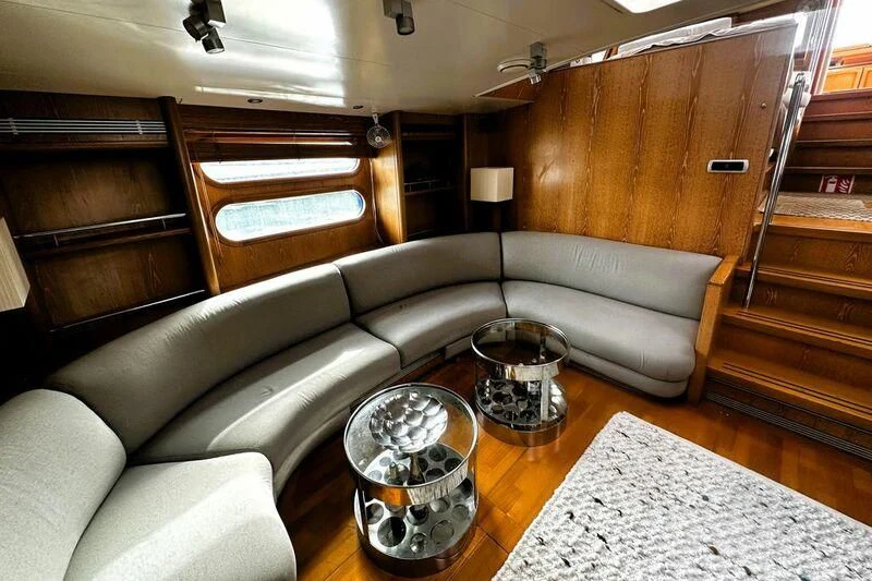 a living room with a couch and coffee table aboard SONGBIRD OF LONDON Yacht for Sale