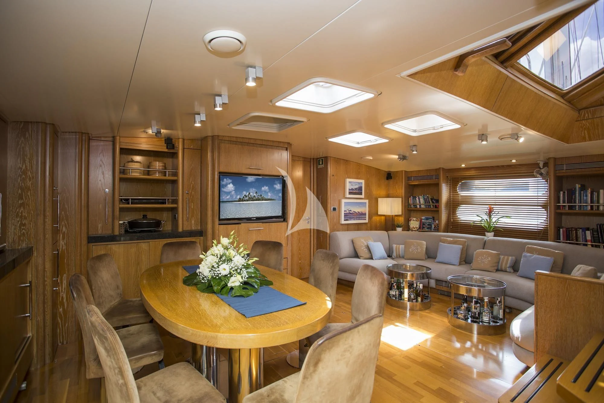 a living room with a large screen aboard SONGBIRD OF LONDON Yacht for Sale
