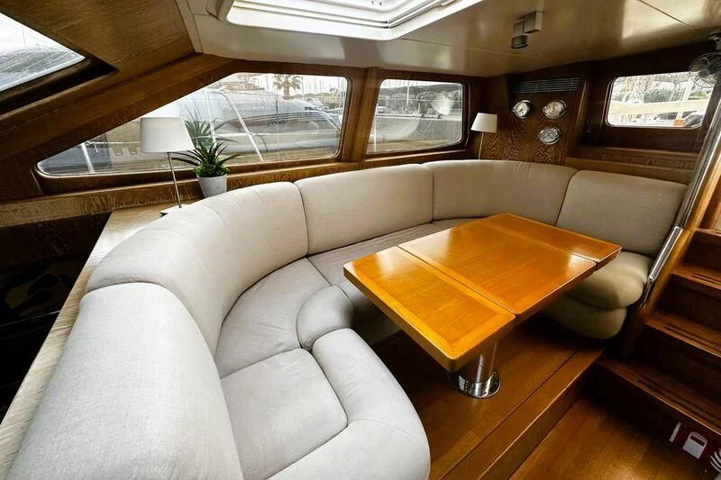 a living room with a couch and a coffee table aboard SONGBIRD OF LONDON Yacht for Sale
