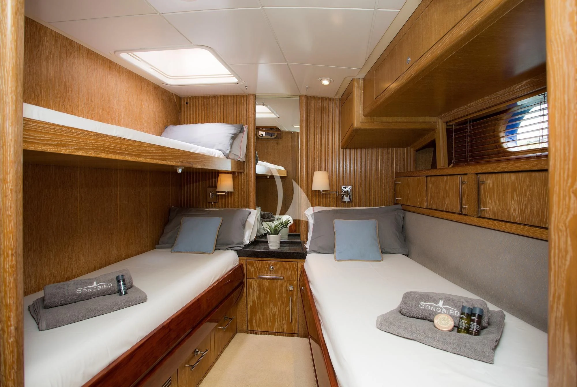 a room with a bed and a table aboard SONGBIRD OF LONDON Yacht for Sale