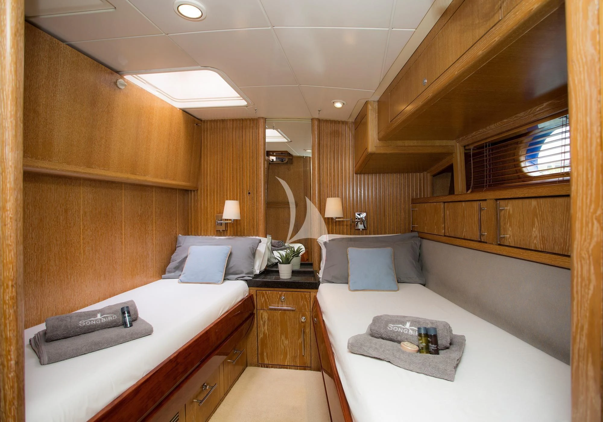 a room with a bed and a mirror aboard SONGBIRD OF LONDON Yacht for Sale