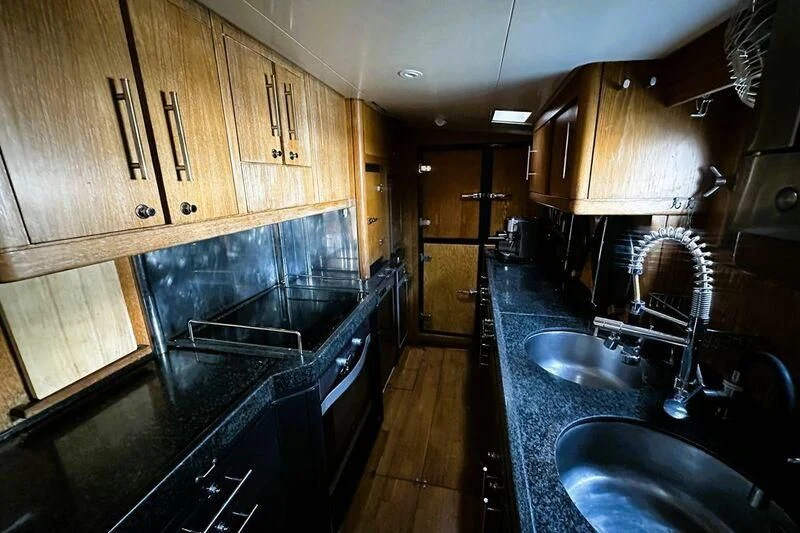 a kitchen with a marble counter top aboard SONGBIRD OF LONDON Yacht for Sale