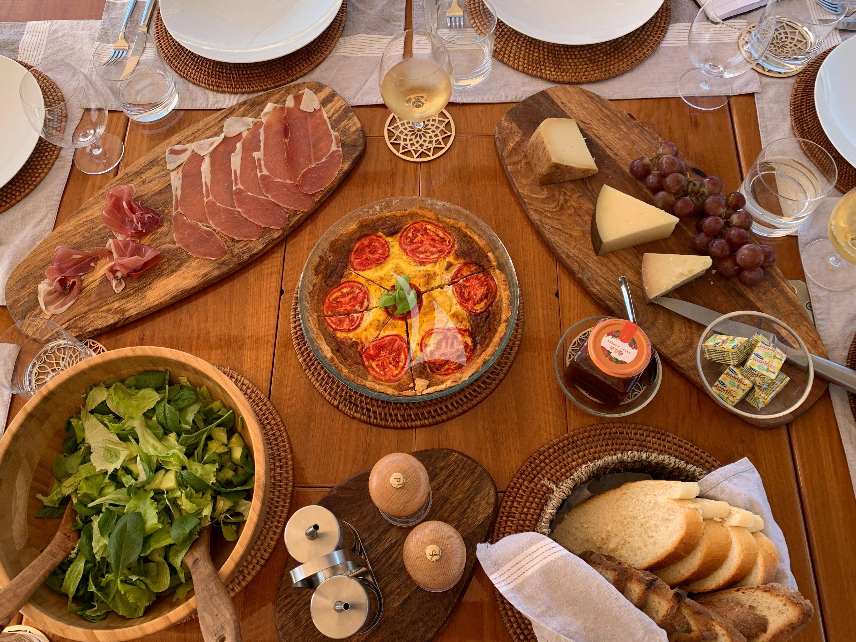 a table with food and dishes on it aboard SONGBIRD OF LONDON Yacht for Sale
