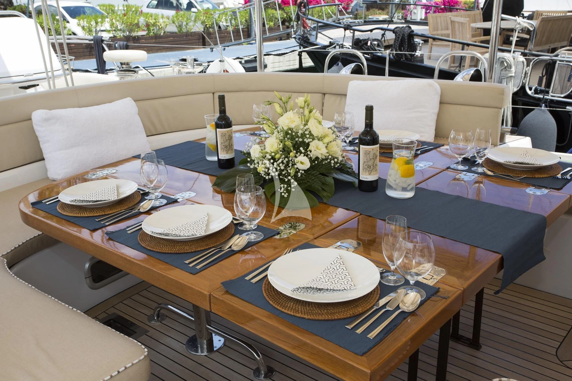 a table with plates and wine bottles aboard SONGBIRD OF LONDON Yacht for Sale