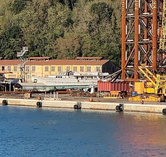 a building under construction next to a body of water aboard EUTOPIA Yacht for Sale