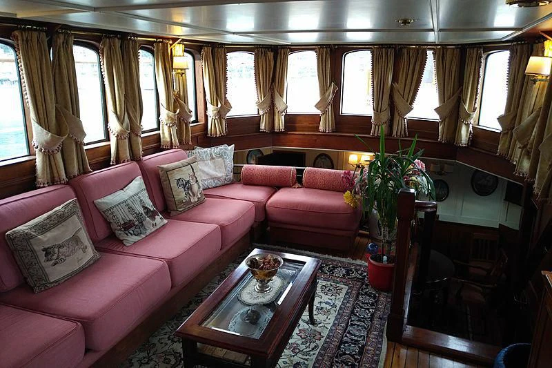 a living room with a pink couch aboard MELTEMI Yacht for Sale