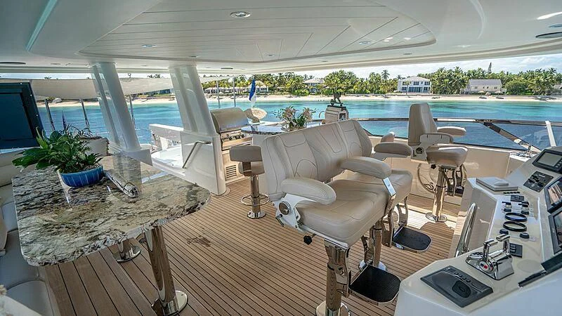 a room with a table chairs and a pool aboard BLACK SWAN Yacht for Sale