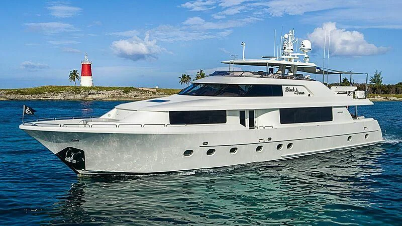 a white yacht in the water aboard BLACK SWAN Yacht for Sale
