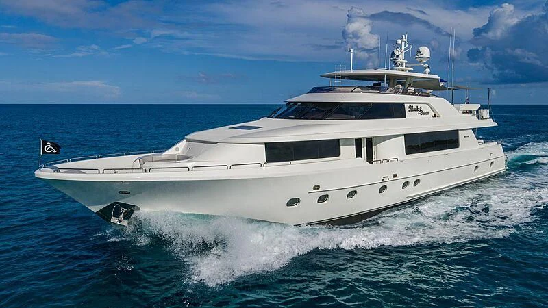 a white yacht on the water aboard BLACK SWAN Yacht for Sale