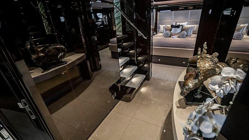 a room with a large display of hats and a bed aboard BLACK SWAN Yacht for Sale