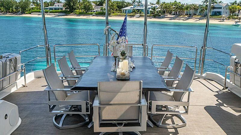 a table and chairs on a deck aboard BLACK SWAN Yacht for Sale