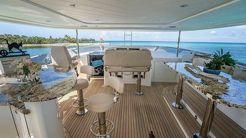 a deck with chairs and tables aboard BLACK SWAN Yacht for Sale