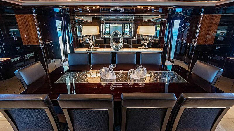 a room with a table and chairs aboard BLACK SWAN Yacht for Sale