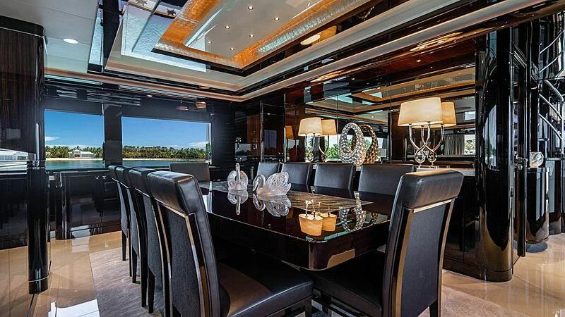 a dining room with a table and chairs aboard BLACK SWAN Yacht for Sale