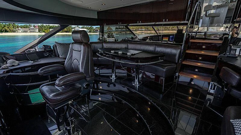 a room with a table and chairs aboard BLACK SWAN Yacht for Sale