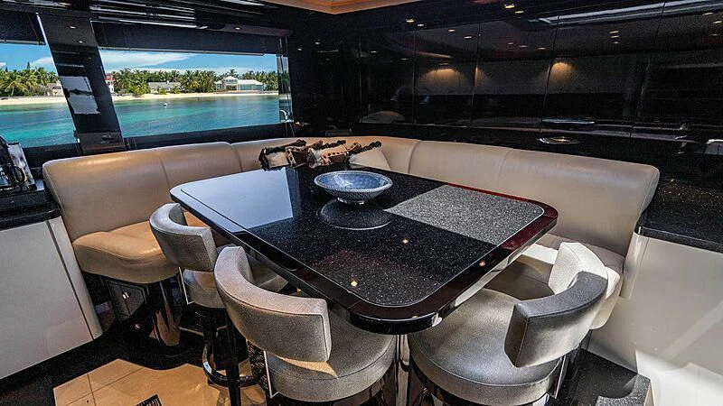 a table with chairs around it aboard BLACK SWAN Yacht for Sale