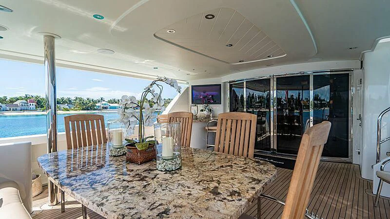 a dining table on a deck aboard BLACK SWAN Yacht for Sale