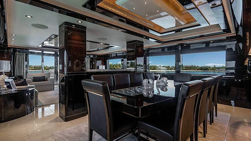 a large room with a table and chairs aboard BLACK SWAN Yacht for Sale