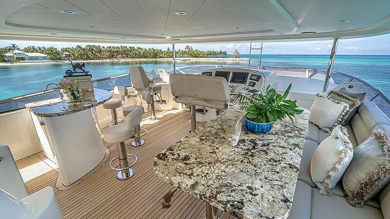 a large room with a table and chairs and a large body of water aboard BLACK SWAN Yacht for Sale