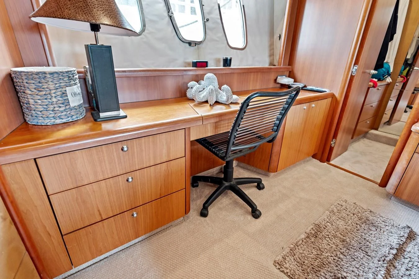 a desk with a chair and a rug on it aboard PERSISTENCE Yacht for Sale