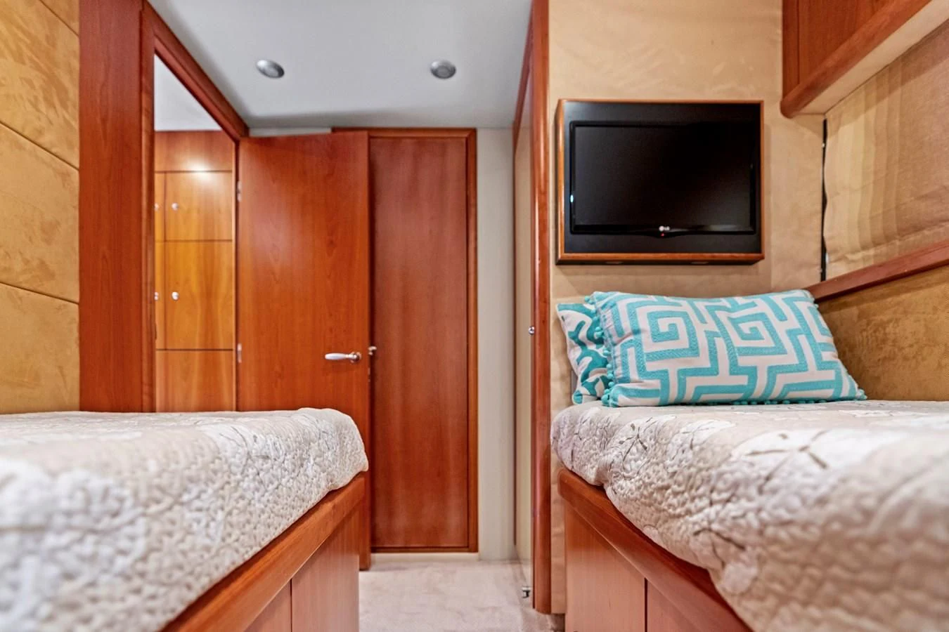 a bedroom with a bed and a television aboard PERSISTENCE Yacht for Sale