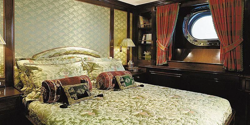 a bed with a mirror and pillows aboard ROCK & ROLL Yacht for Sale