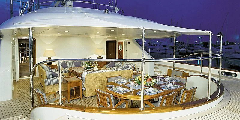 a large room with a table and chairs aboard ROCK & ROLL Yacht for Sale