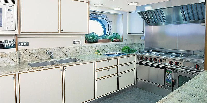 a kitchen with white cabinets aboard ROCK & ROLL Yacht for Sale