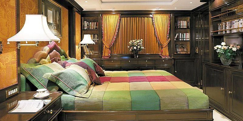 a bed with green sheets aboard ROCK & ROLL Yacht for Sale