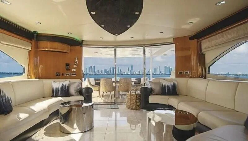a living room with a large window aboard SO WHAT WHO CARES Yacht for Sale