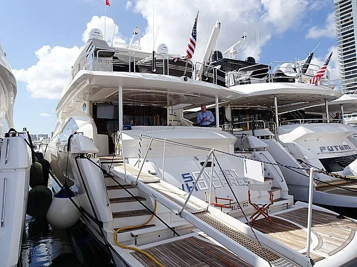 a boat with a person sitting on it aboard SO WHAT WHO CARES Yacht for Sale