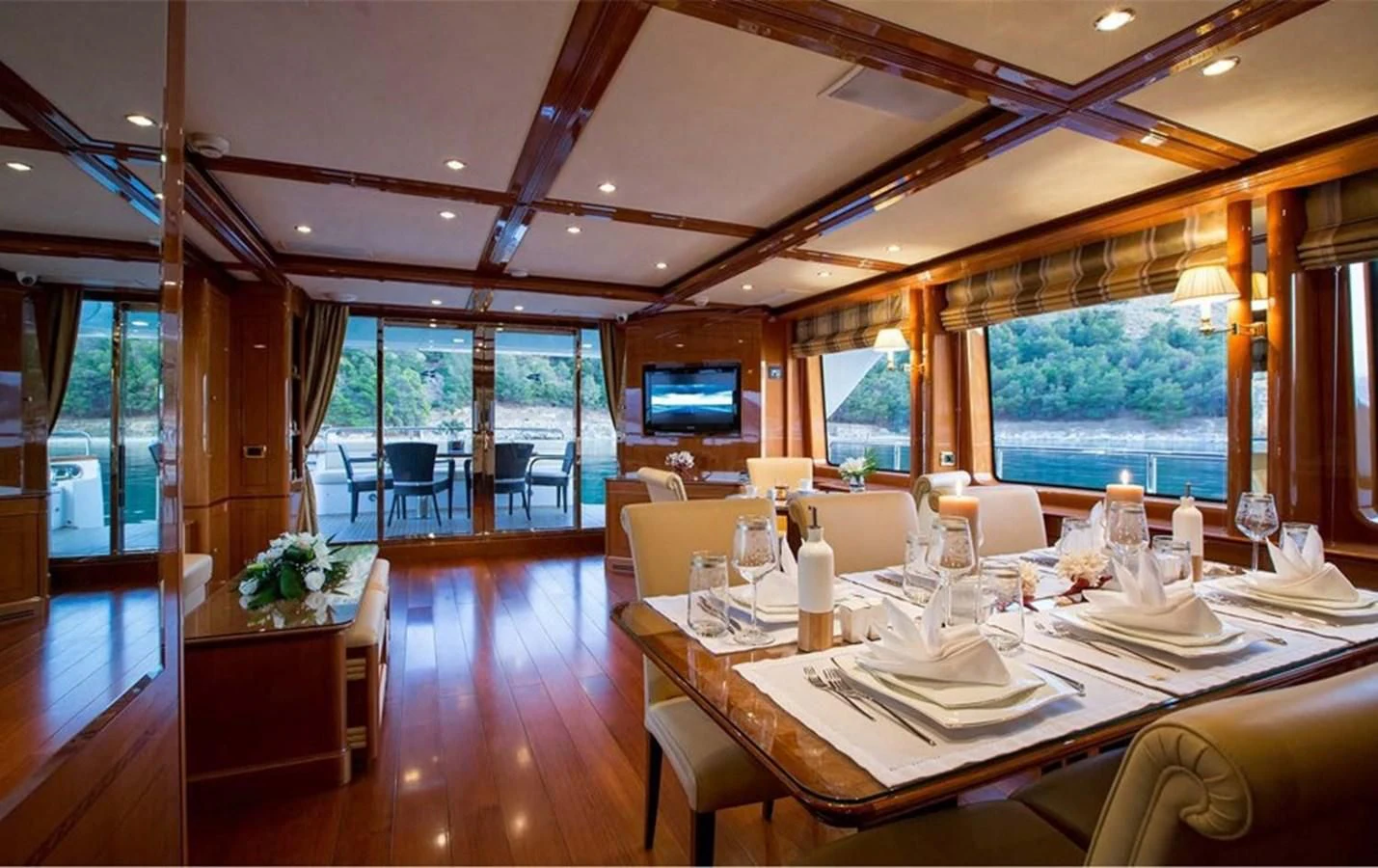 a room with tables and chairs aboard REBECCA V Yacht for Sale
