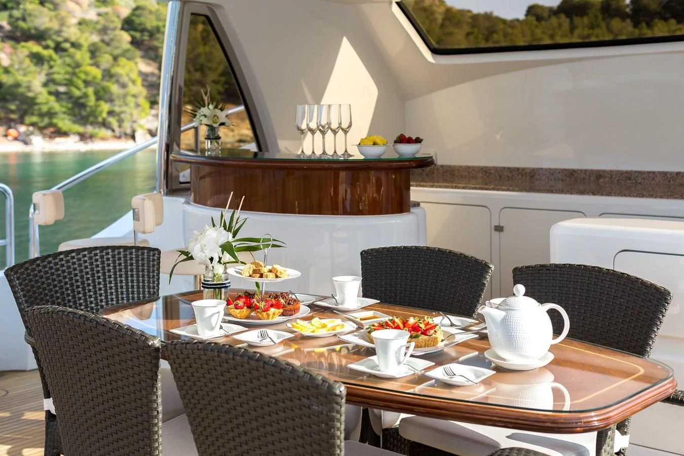 a table with chairs and a vase of flowers on it aboard REBECCA V Yacht for Sale