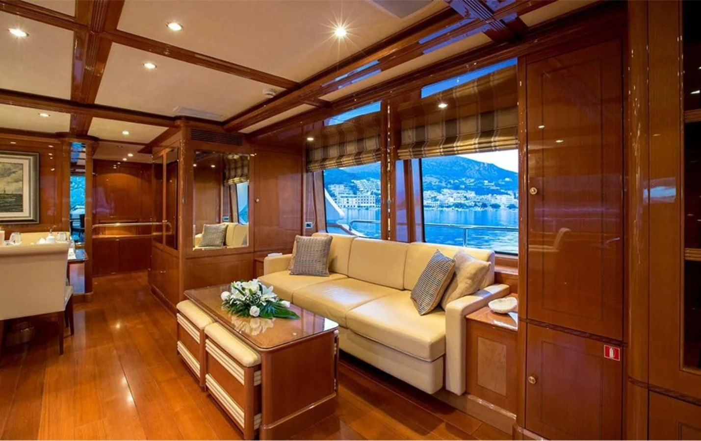 a living room with a large window aboard REBECCA V Yacht for Sale