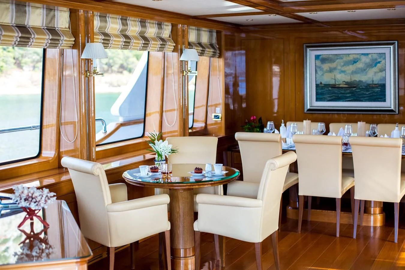 a room with a table chairs and a television aboard REBECCA V Yacht for Sale