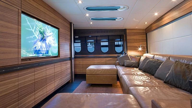 a living room with a large screen aboard VITAMIN SEA I Yacht for Sale