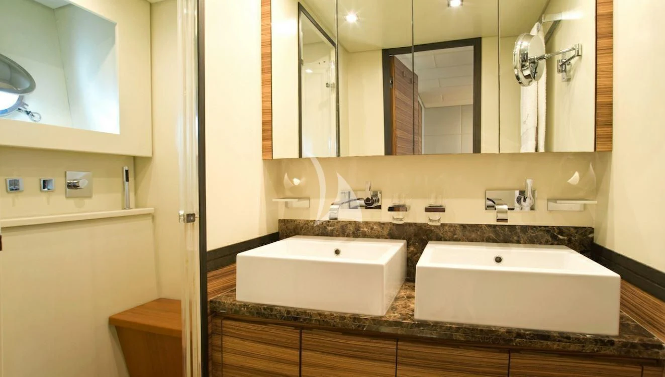a bathroom with a large mirror aboard VITAMIN SEA I Yacht for Sale