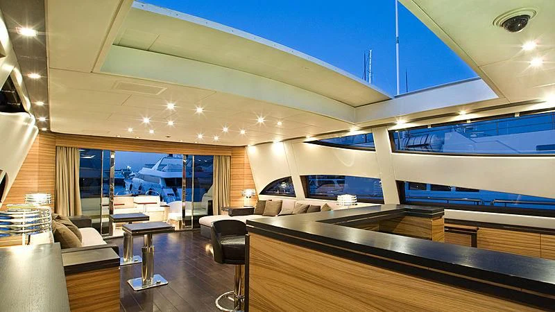 a room with a large window and a wood table with chairs and a large window aboard VITAMIN SEA I Yacht for Sale