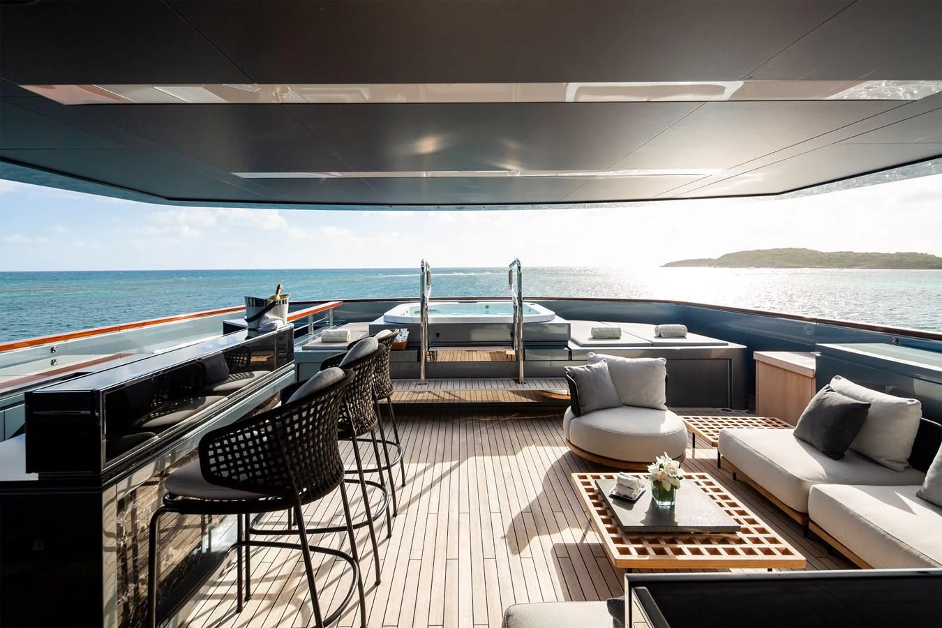a room with a table chairs and a large body of water aboard FIFTY Yacht for Charter